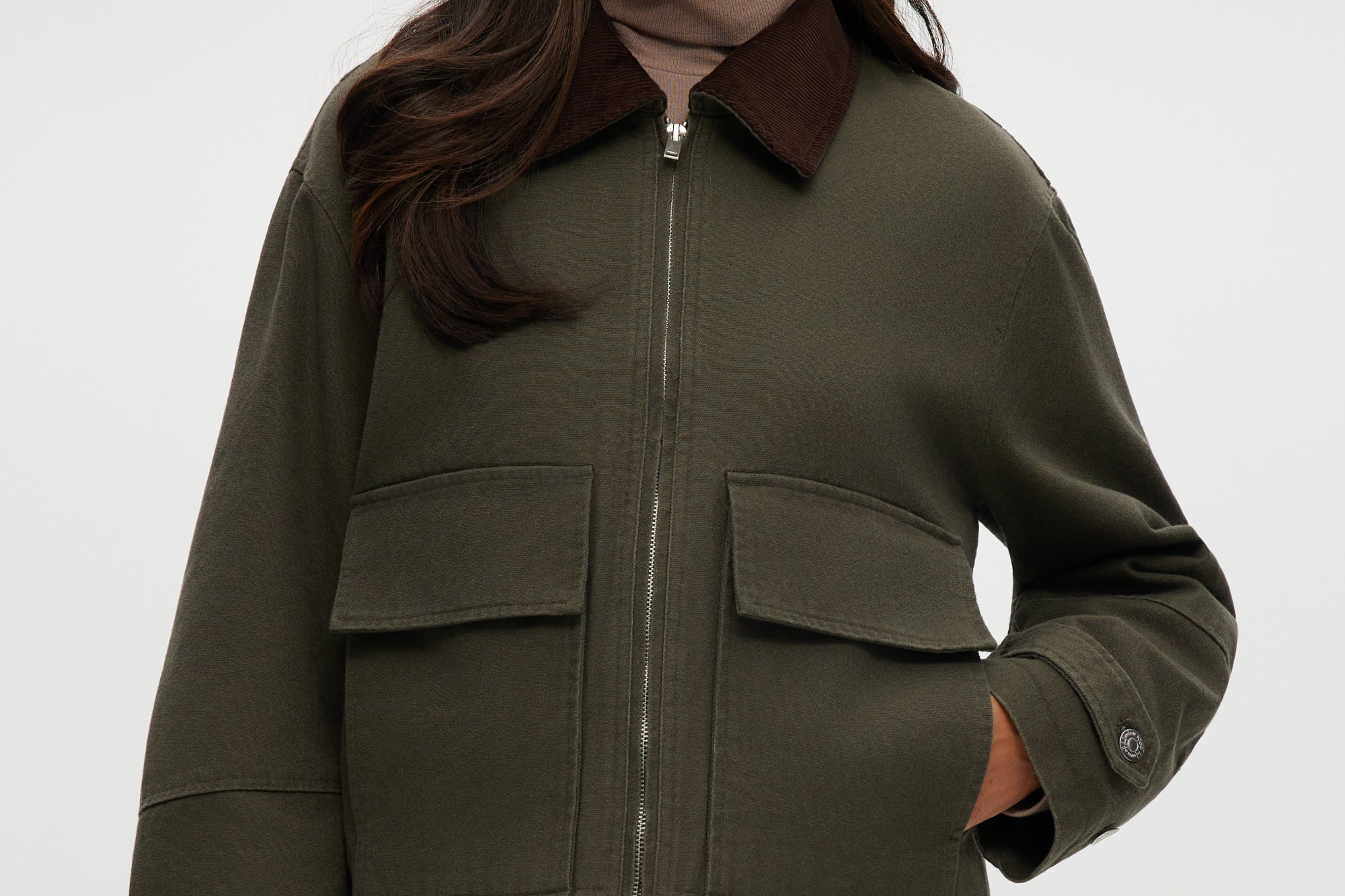 Olive green cotton canvas jacket with contrasting collar, zip-front, and patch pockets.