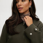 Olive green cotton canvas cropped jacket featuring a contrasting collar, zip-front, and patch pockets by Hilary Radley.