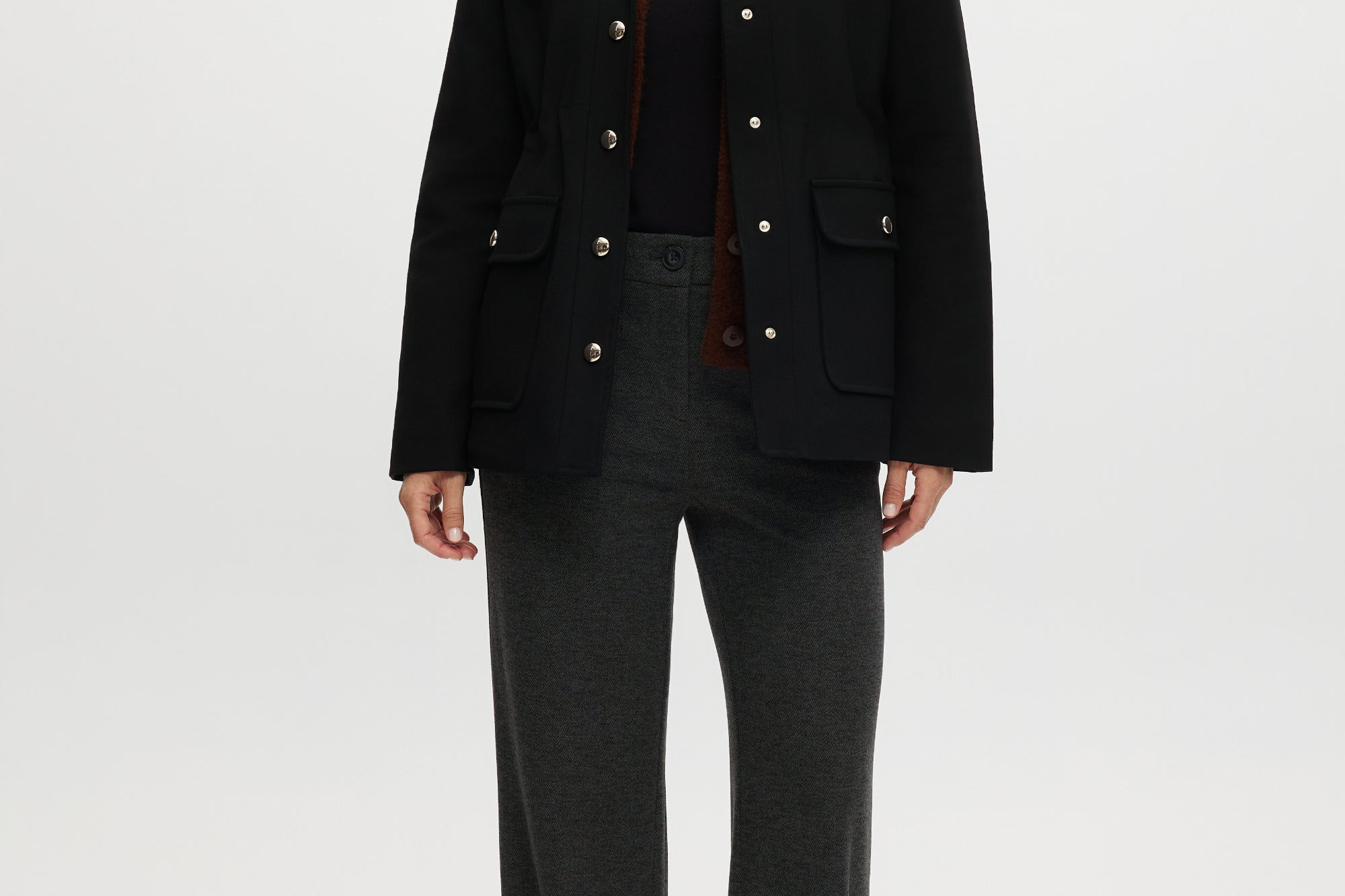 Black utility jacket featuring a brown contrast collar and flap pockets by Hilary Radley.