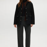 Black utility jacket featuring a brown contrast collar and flap pockets by Hilary Radley.