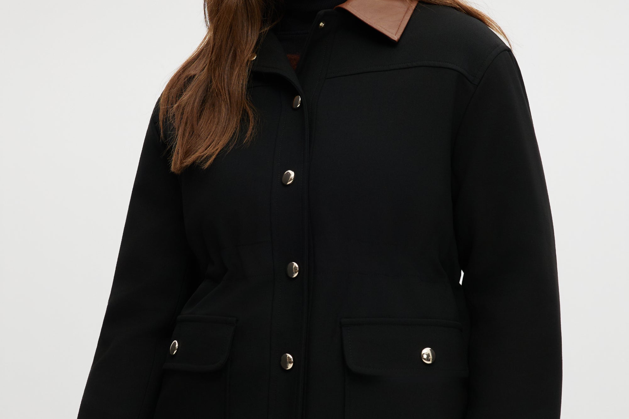 Black utility jacket with brown contrast collar and flap pockets.