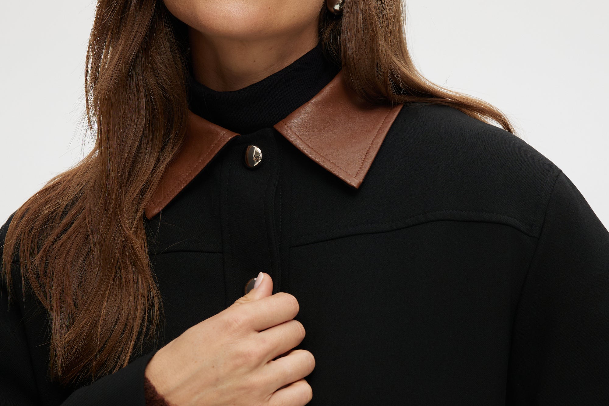 Black utility jacket with a brown contrast collar and flap pockets by Hilary Radley.
