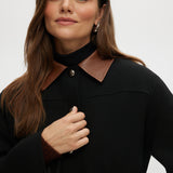 Black utility jacket with a brown contrast collar and flap pockets by Hilary Radley.