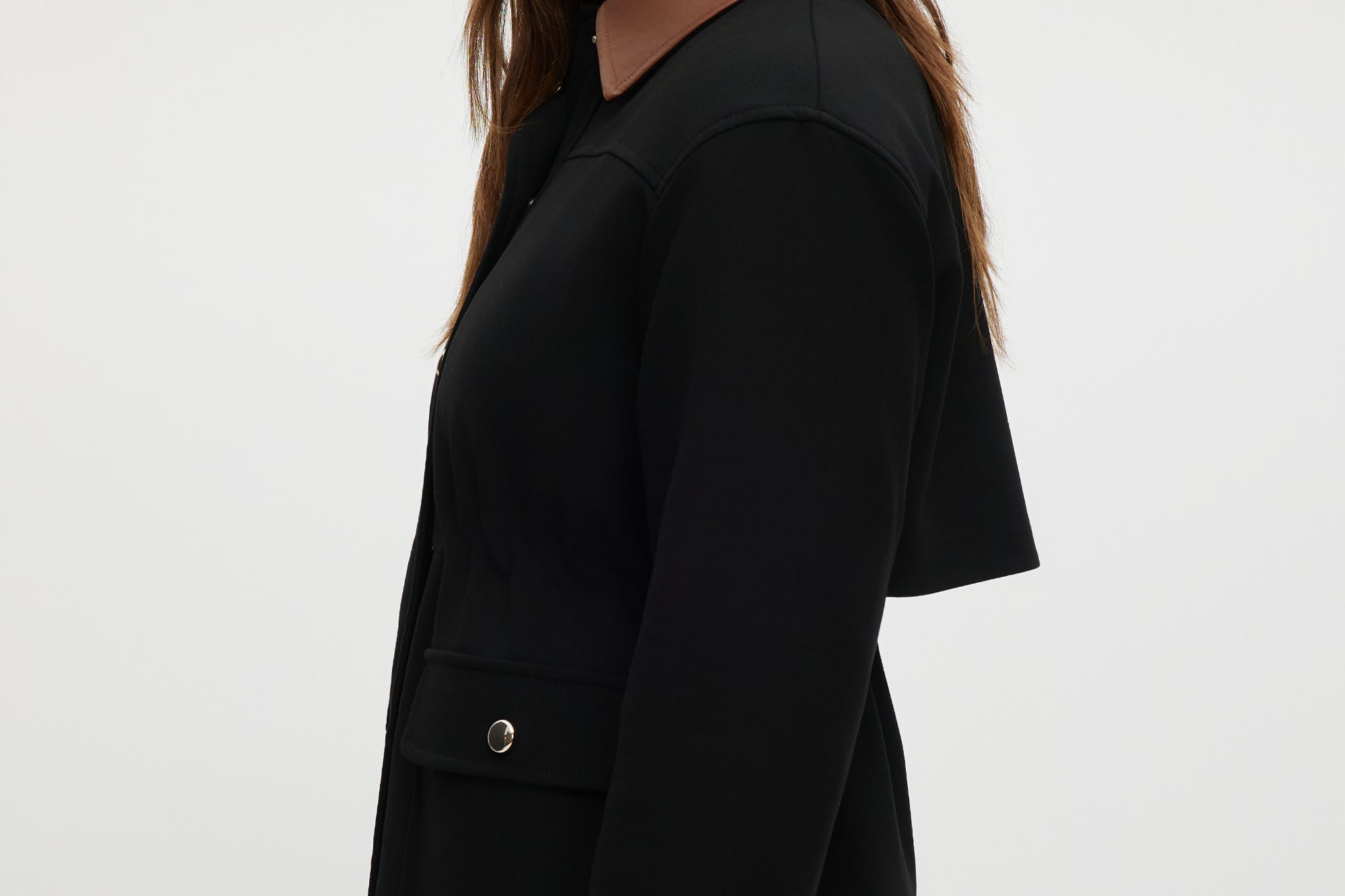 Black utility jacket featuring a brown contrast collar and flap pockets by Hilary Radley.