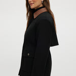 Black utility jacket featuring a brown contrast collar and flap pockets by Hilary Radley.