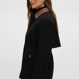 Black utility jacket featuring a brown contrast collar and flap pockets by Hilary Radley.