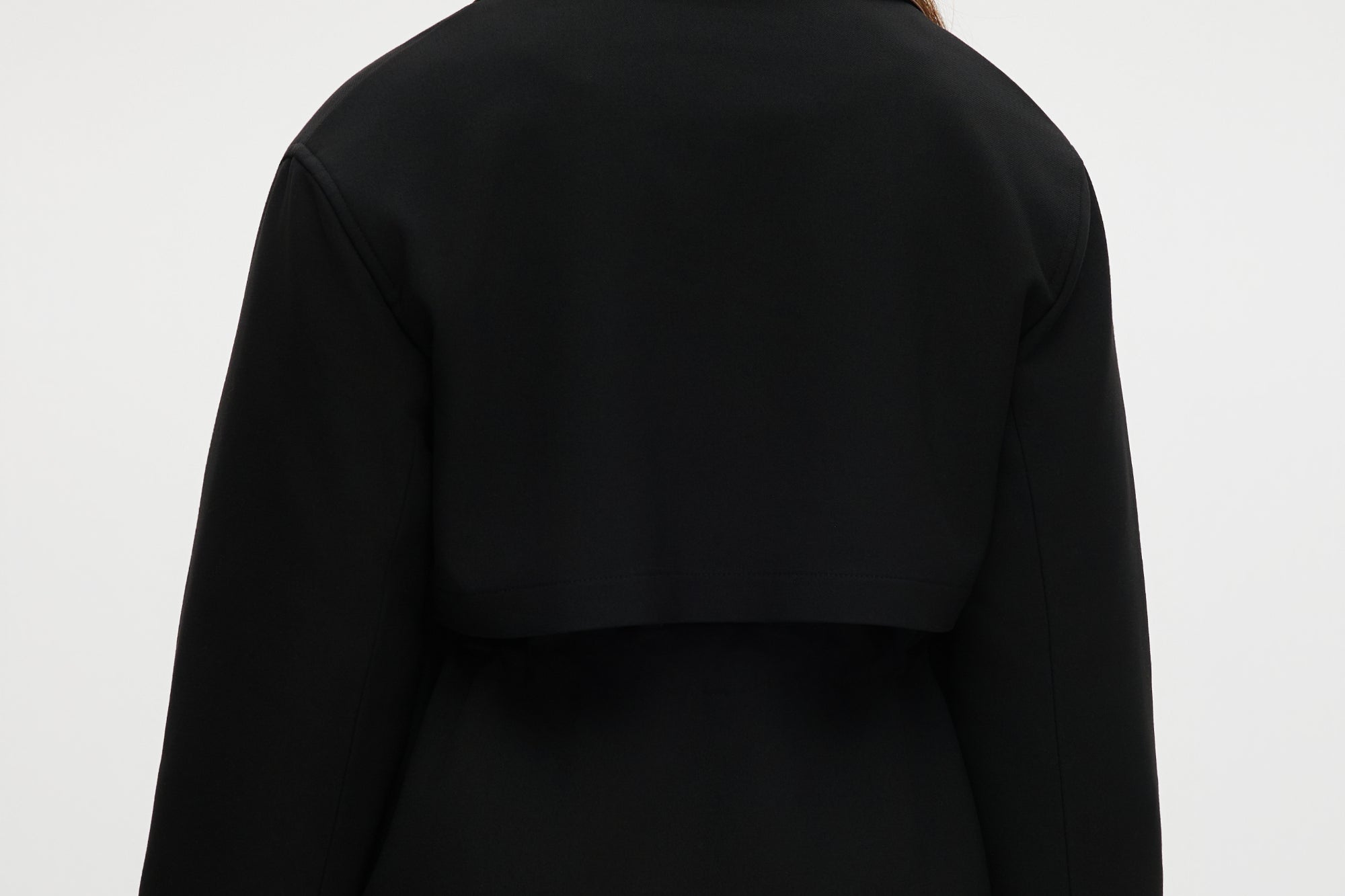 Black utility jacket featuring a brown contrast collar and flap pockets by Hilary Radley.
