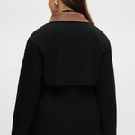 Black utility jacket featuring a brown contrast collar and flap pockets by Hilary Radley.