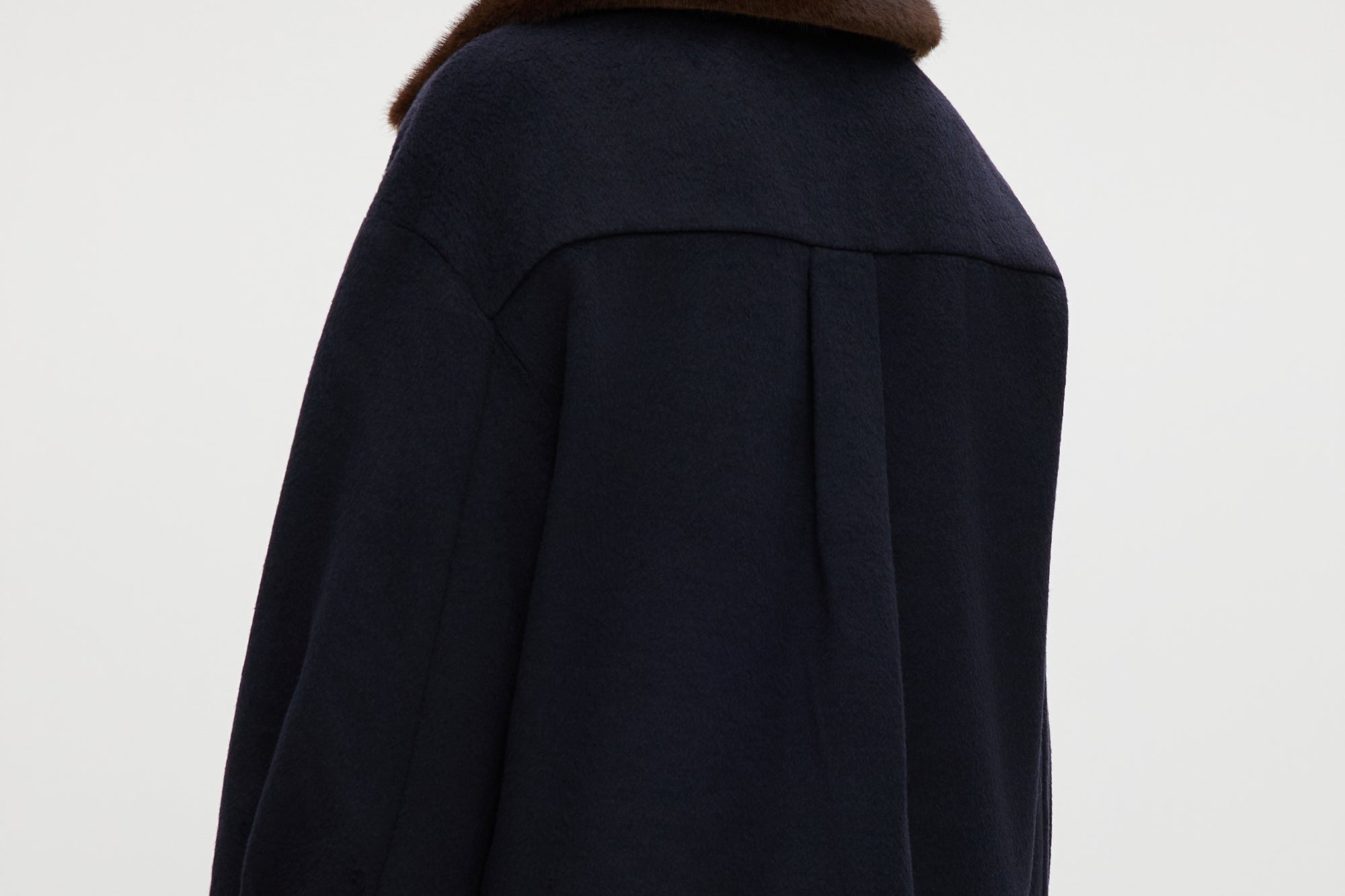 Navy wool-like boxy jacket featuring a removable faux fur collar and silver-tone buttons by Hilary Radley.