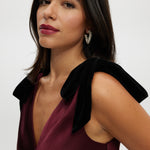 Bordeaux Satin Maxi Dress featuring elegant velvet bow shoulder details, a sleeveless design, and V-neckline by Hilary Radley.