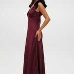 Bordeaux satin maxi dress featuring velvet bow shoulder details, sleeveless design, and V-neckline by Hilary Radley.