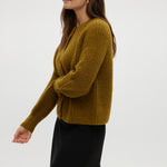 Mustard shaker stitch raglan cardigan featuring button closure and ribbed texture by Hilary Radley.