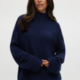 Navy rolled neck cotton sweater with ribbed details and oversized fit.