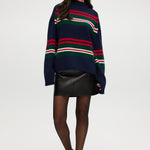 Navy Stripe Rolled Neck Sweater featuring red, green, and white stripes with a high neck and long sleeves by Hilary Radley.