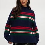 Navy sweater with red, green, and white stripes, high neck, long sleeves.