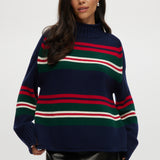 Navy sweater with red, green, and white stripes, high neck, long sleeves.