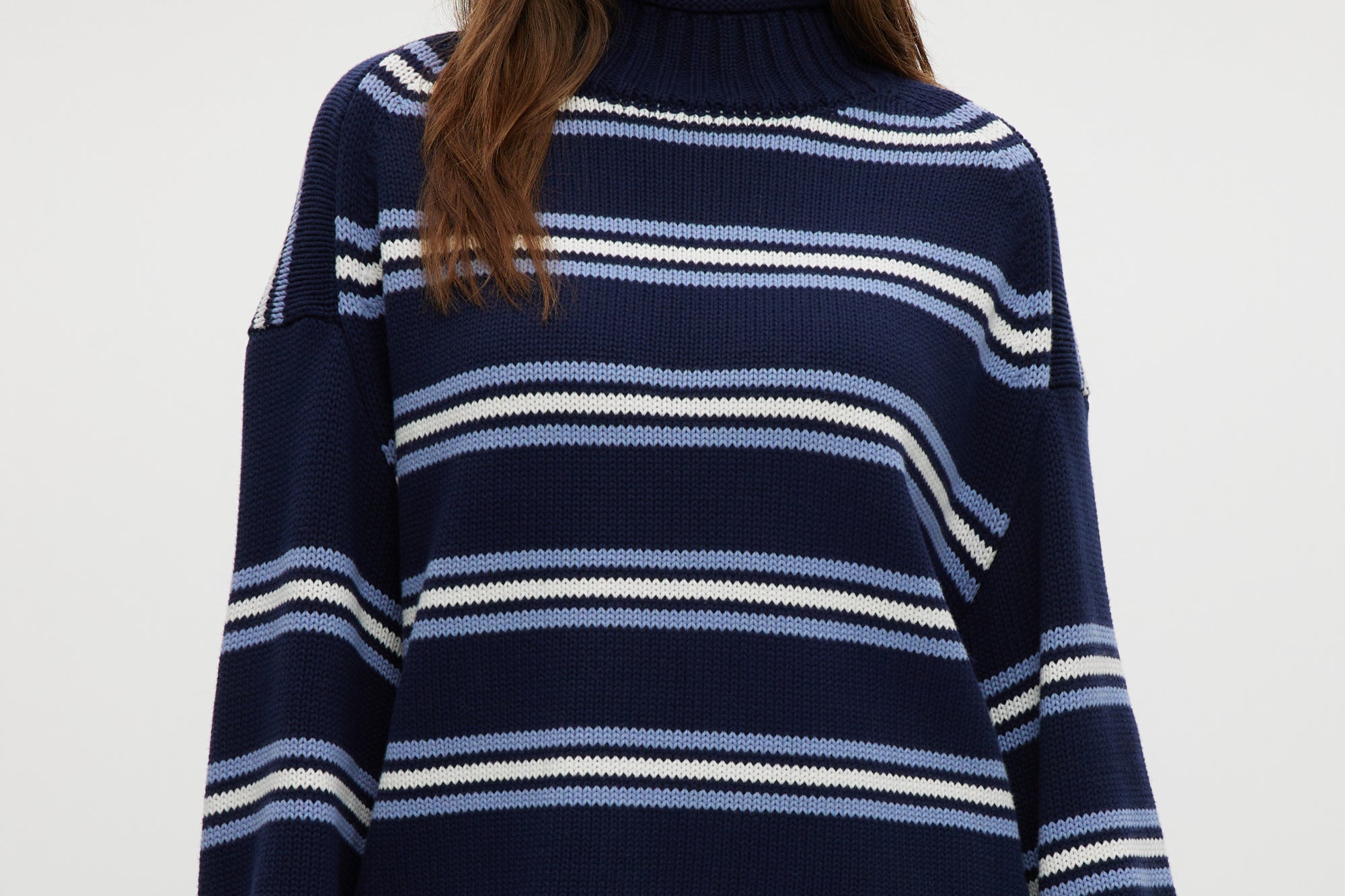 Navy striped rolled neck sweater with long sleeves and relaxed fit.